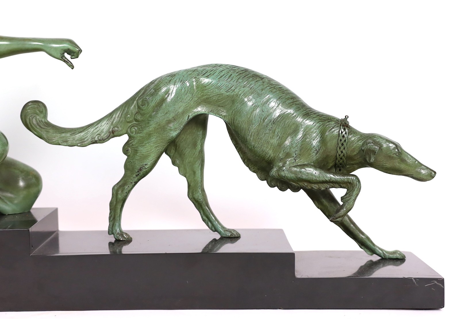 Armand Godard. A French Art Deco patinated bronze and black marble group of a classical woman and borzoi, 80cm wide, 37cm high